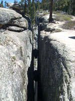 a crevasse with a boulder wedged in