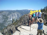 posing at railing with yosemite falls in the background